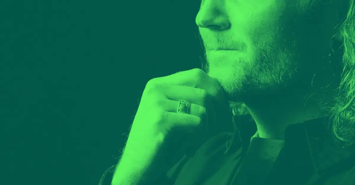 Man with hand on chin